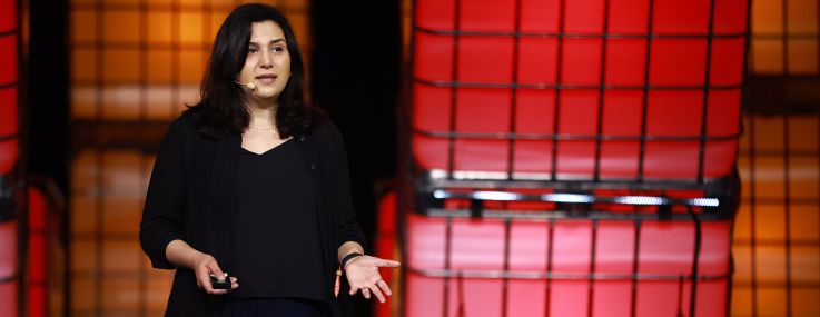 A woman speaking on stage.