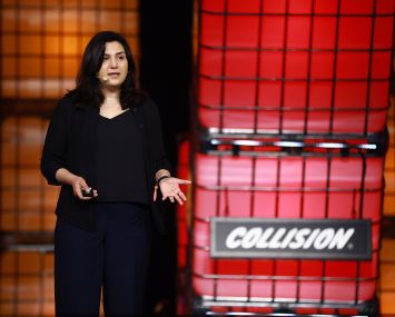 A woman speaking on stage.