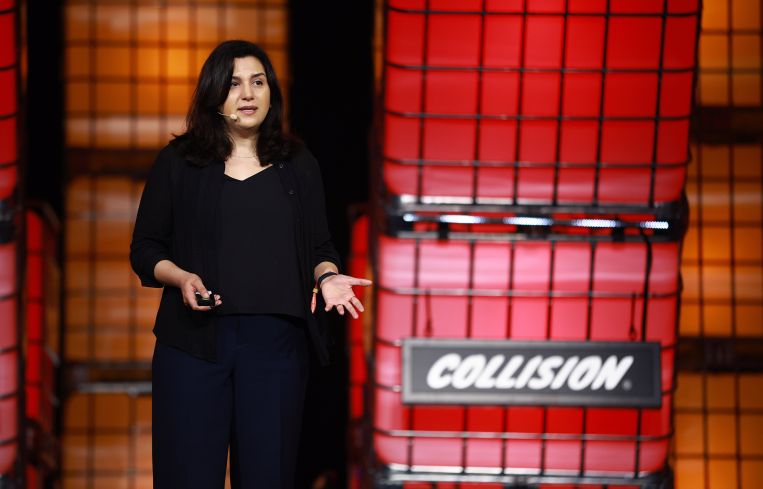 A woman speaking on stage.