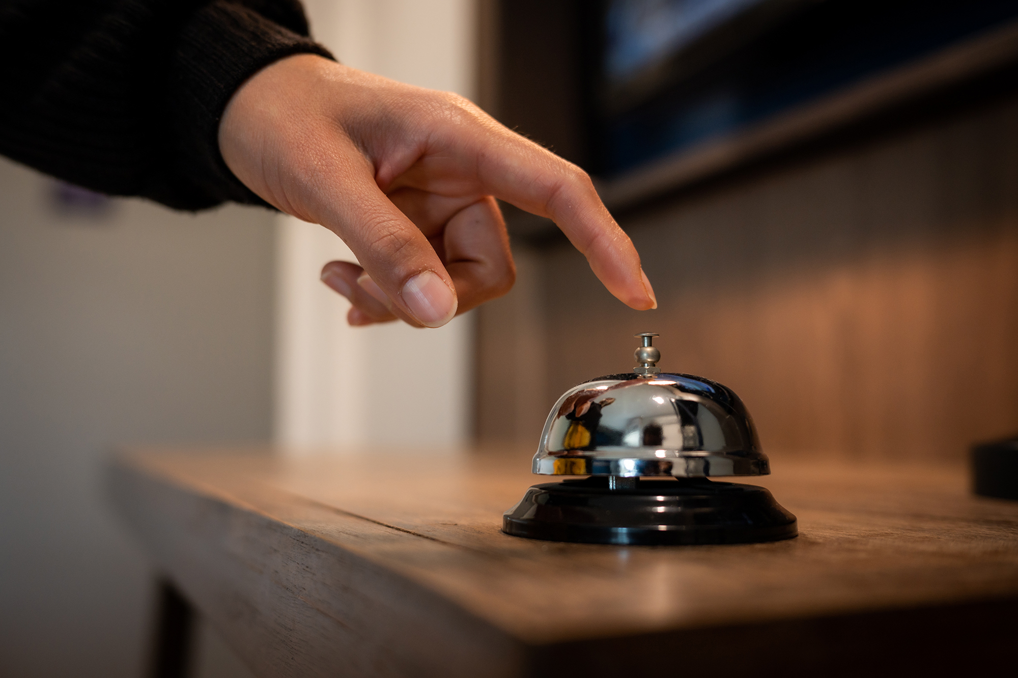 A guest ringing a hotel bell.