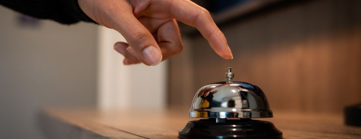 A guest ringing a hotel bell.
