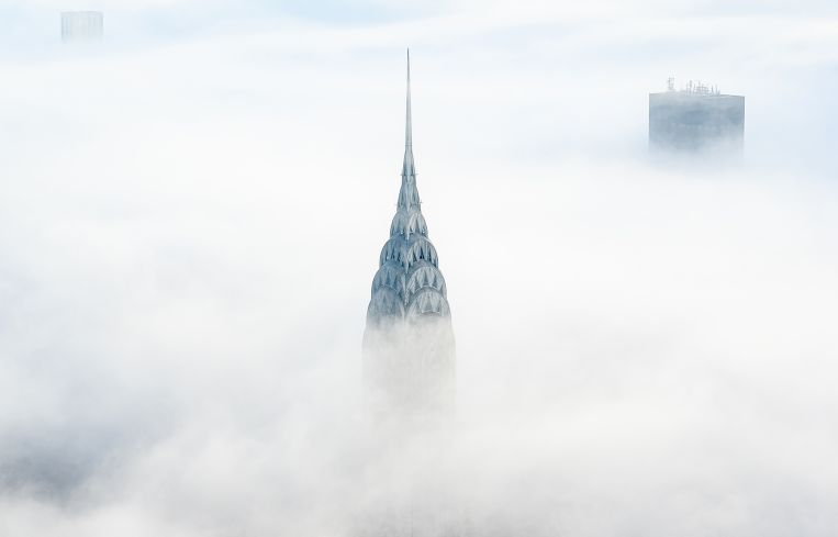The Chrysler Building protrudes above the clouds in Manhattan.