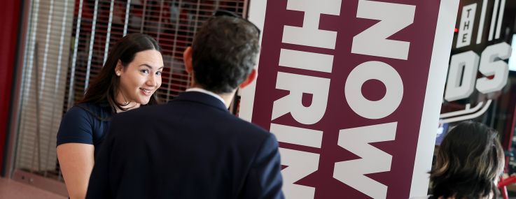 People wait in line at a job fair in Sunrise, Fla.