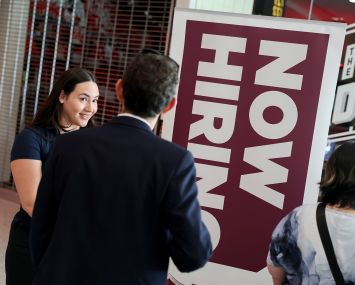People wait in line at a job fair in Sunrise, Fla.