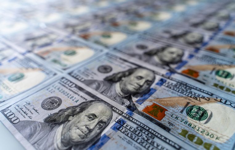 Hundred dollar bills in a sheet.