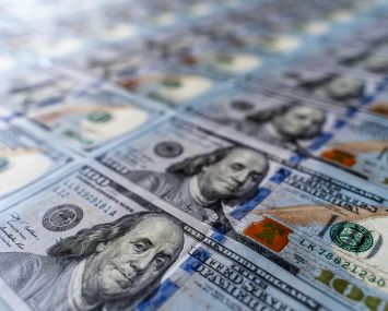 Hundred dollar bills in a sheet.