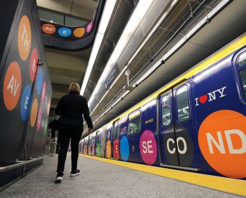 A woman walks to a train at the 96th Street station on the Second Avenue subway line.