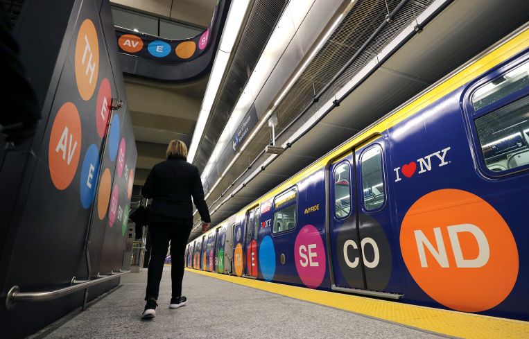 A woman walks to a train at the 96th Street station on the Second Avenue subway line.