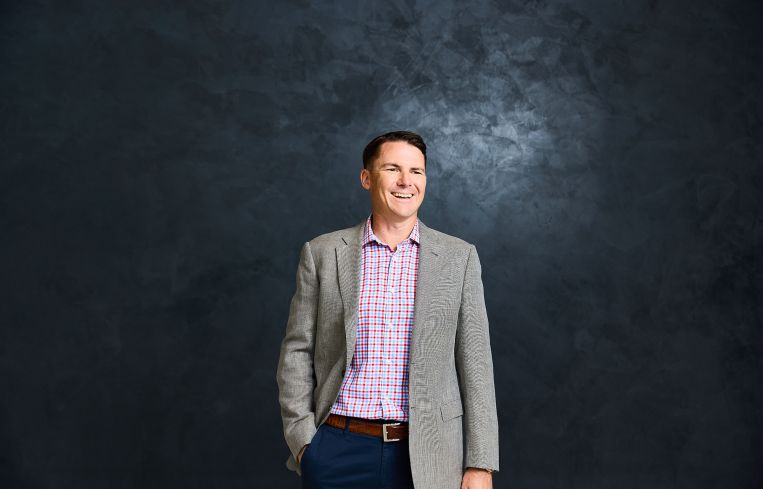 A man standing and smiling.