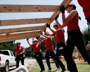 Volunteers with San Gabriel Valley Habitat for Humanity on June 26 help construct walls which will be used to build new homes for Altadena Eaton Fire victims in Pasadena, California.
