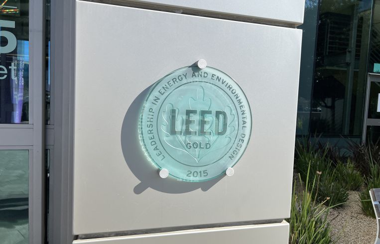 Glass emblem on the exterior of a building certifying the building for LEED energy efficiency.