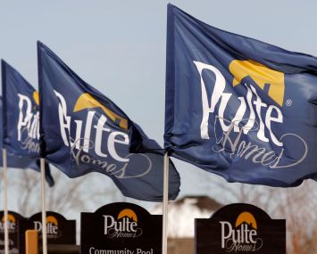 Flags bearing the Pulte Homes logo blow in the wind.