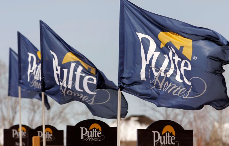 Flags bearing the Pulte Homes logo blow in the wind.