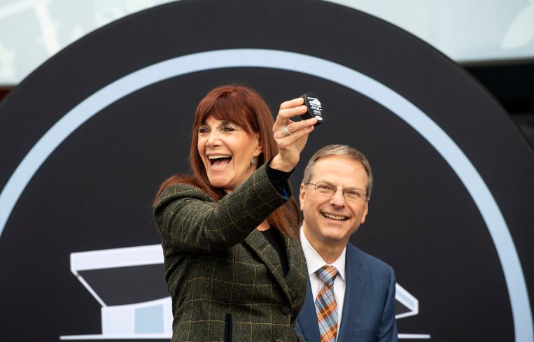 Susan Samueli, and her husband Henry Samueli, show off the ceremonial first puck at Great Park Ice at the Great Park in Irvine, Calif.