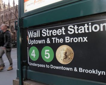 An image of a NYC subway sign, and one of the subway trains is the Bitcoin logo.