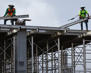 Construction workers help build a mixed-use apartment complex in Los Angeles, Calif.