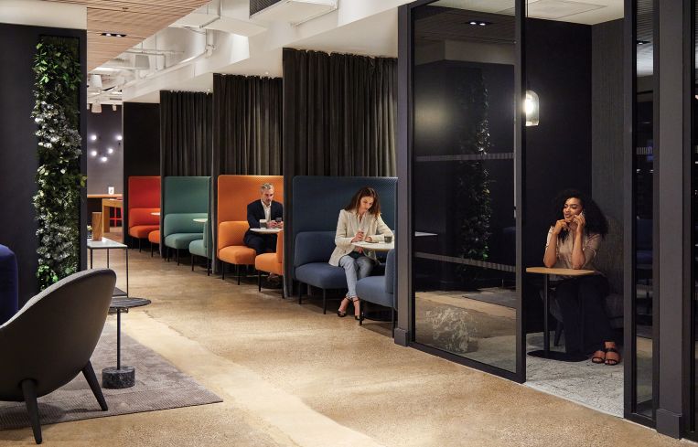 Tenants can work or eat at communal tables, on comfy couches, or in colorful booth seating.