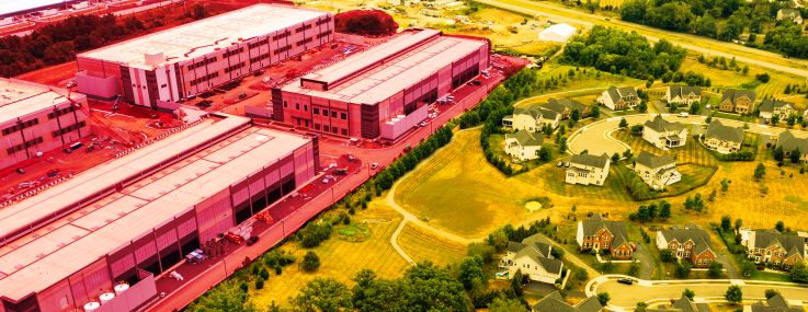 An aerial shot of a data center creeping up on a residential neighborhood.