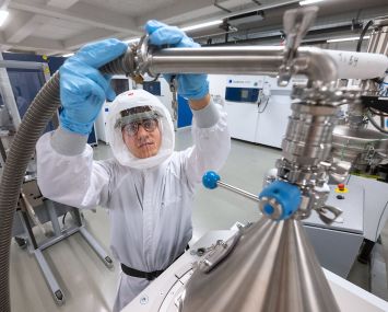 A laser specialist assembles an extraction hose.