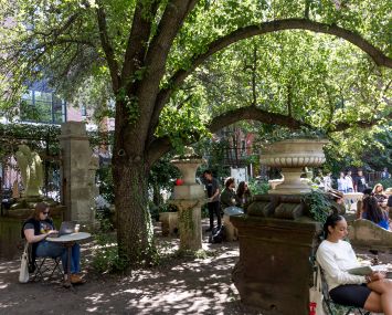 A small urban park with people in it.