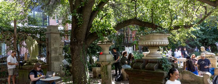 A small urban park with people in it.