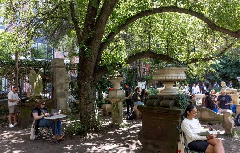A small urban park with people in it.