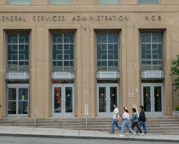 People walk by the General Services Administration (GSA) building in Washington, D.C.