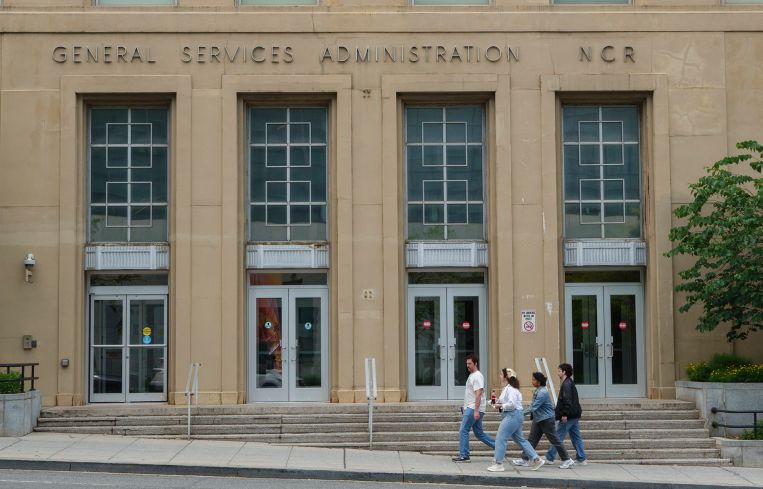 People walk by the General Services Administration (GSA) building in Washington, D.C.