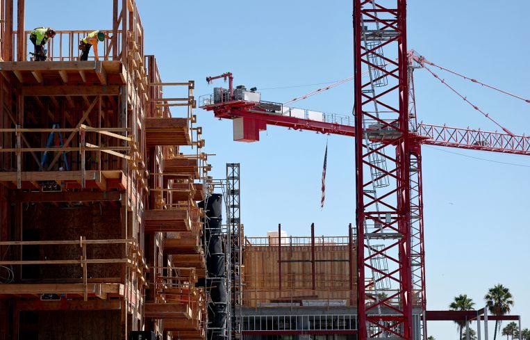 Construction continues on a mixed-use apartment complex in Los Angeles.