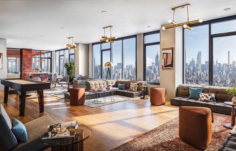 The 40th-floor lounging and coworking space features a kitchen area, a shuffleboard table, floor-to-ceiling windows with eye-catching city views.
