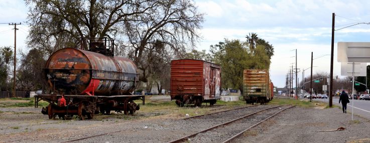 A vacant lot except for three old train cars.