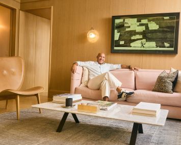 A man reclining on an office couch.