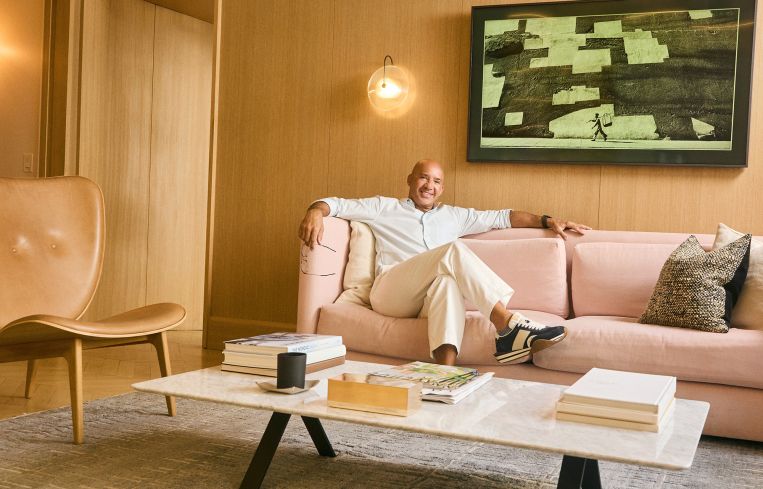 A man reclining on an office couch.