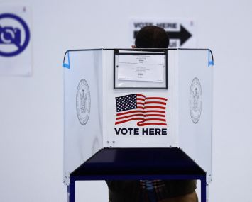 A voter casts their ballot at a polling station in the Bloomberg building at Hudson Yards during the first day of early in New York on October 26, 2024.