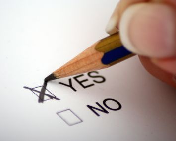 A pencil marking a "yes" vote.