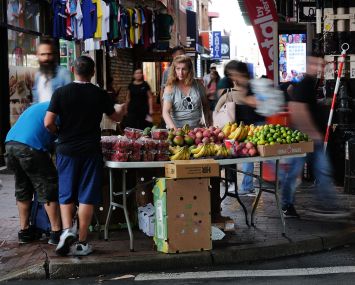 A street vendor sells fruit along Roosevelt Avenue in Queens.