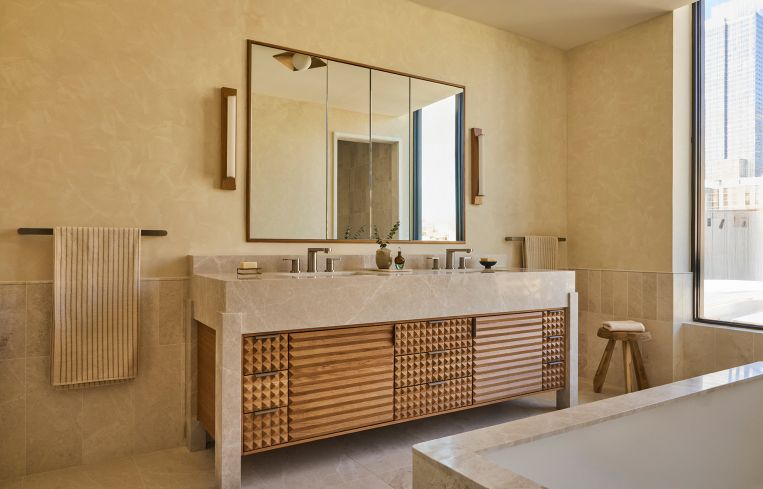 The bathroom sinks are carved from Italian stone.