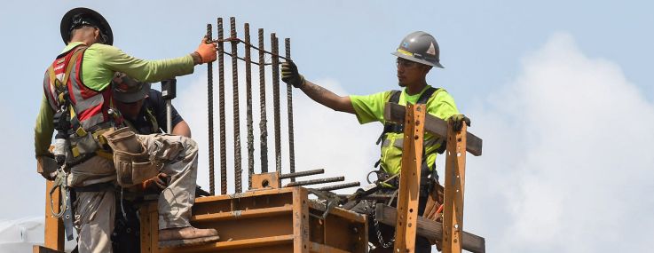 Workers are seen as construction progresses on a large residential project being built in Florida.