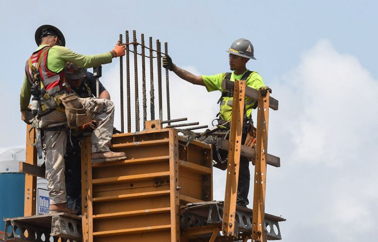 Workers are seen as construction progresses on a large residential project being built in Florida.
