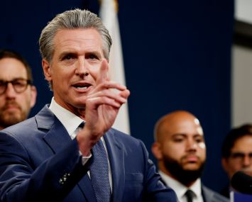 California Gov. Gavin Newsom, with Sen. Scott Wiener back left.