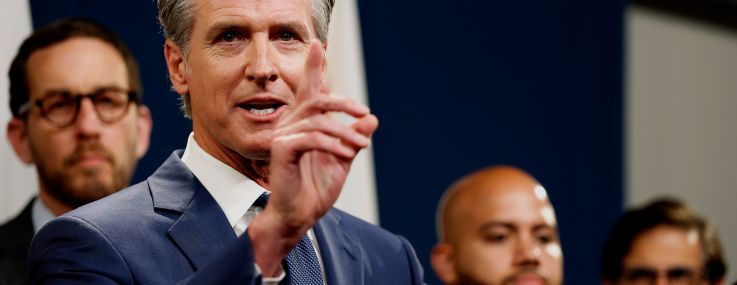 California Gov. Gavin Newsom, with Sen. Scott Wiener back left.