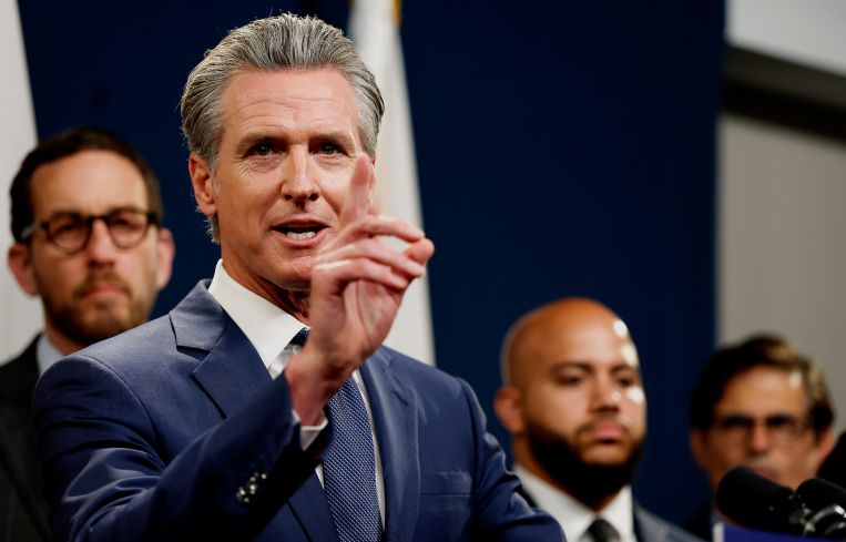 California Gov. Gavin Newsom, with Sen. Scott Wiener back left.