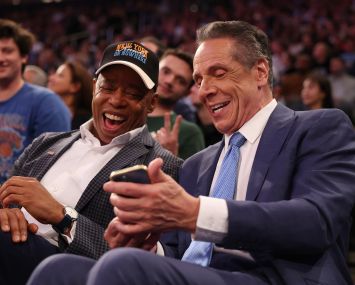 NEW YORK, NEW YORK - OCTOBER 22: New York Mayor Eric Adams sits with Independent candidate former New York Gov. Andrew Cuomo after Cuomo participated in the second debate for the upcoming mayoral election on Wednesday evening during the game between the New York Knicks and the Cleveland Cavaliers at Madison Square Garden on October 22, 2025 in New York City.
