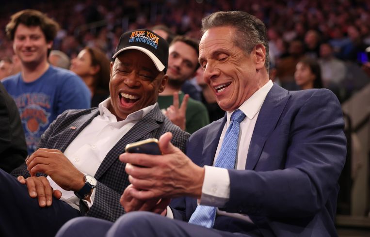 NEW YORK, NEW YORK - OCTOBER 22: New York Mayor Eric Adams sits with Independent candidate former New York Gov. Andrew Cuomo after Cuomo participated in the second debate for the upcoming mayoral election on Wednesday evening during the game between the New York Knicks and the Cleveland Cavaliers at Madison Square Garden on October 22, 2025 in New York City.