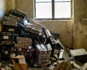 Ruined office of an old abandoned factory with cobwebs.