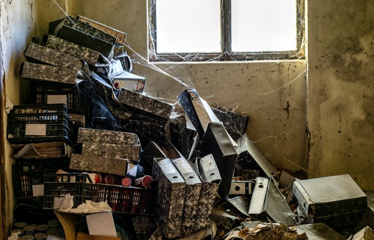 Ruined office of an old abandoned factory with cobwebs.