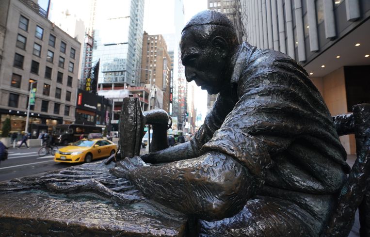 The 8-foot bronze permanent sculpture called "The Garment Worker", created by Judith Weller, stands in the Garment District of Manhattan.