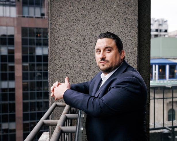 Patrick Arangio of CBRE standing on a balcony at the company's 200 Park Avenue office.
