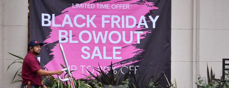 A sign advertising Black Friday sales on a store front in Los Angeles ahead of Thanksgiving holiday.