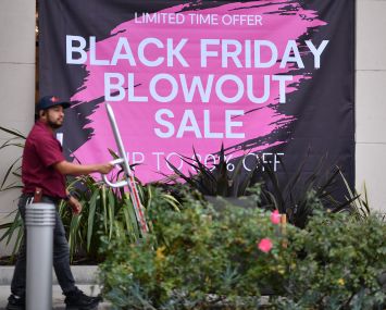 A sign advertising Black Friday sales on a store front in Los Angeles ahead of Thanksgiving holiday.